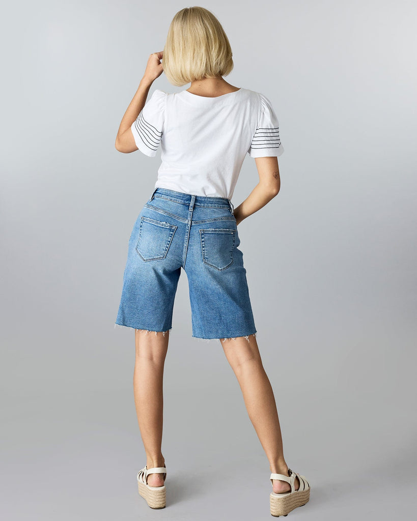 Woman in baggy bermuda shorts.