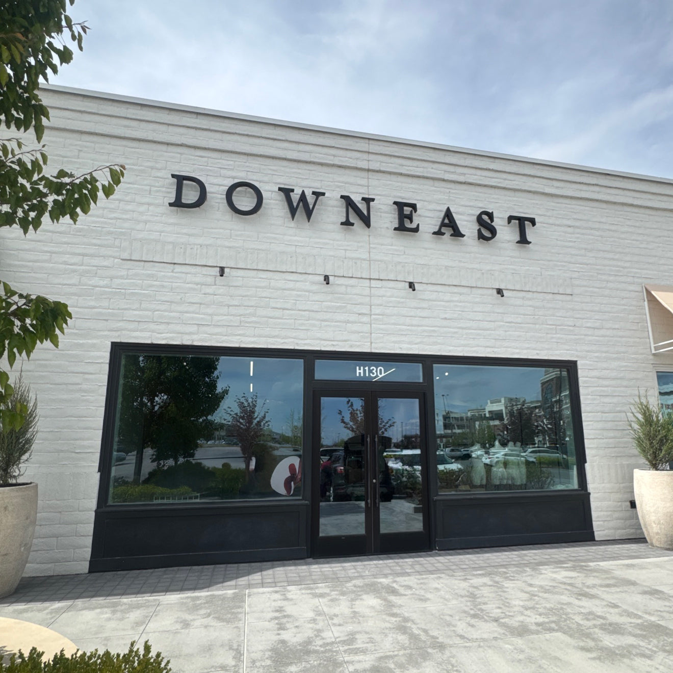 Building facade with 'DOWN EAST' signage and large glass doors.
