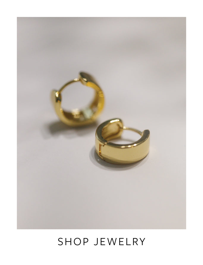 Gold hoop earrings on a light gray background with 'Shop Jewelry' text at the bottom.