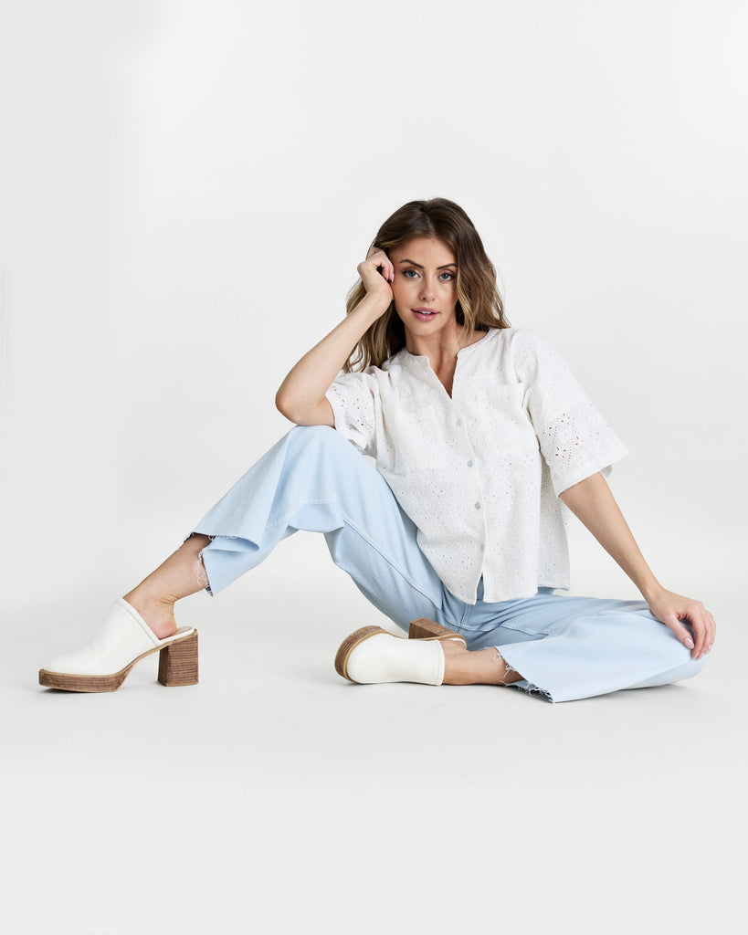 Woman in a white short sleeve buttondown top