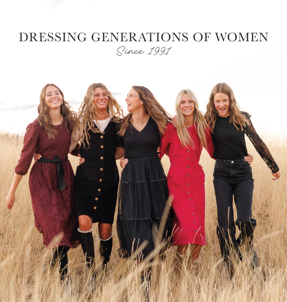 Five women standing together in a field with text 'Dressing Generations of Women Since 1991'.