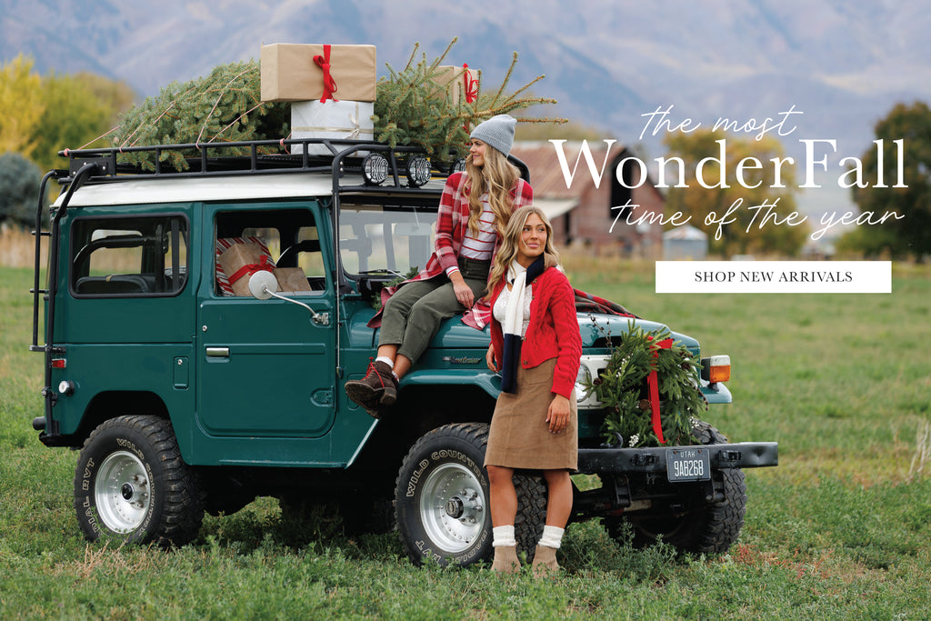 Two women standing next to a green SUV with Christmas decorations in a field. Promotional text overlay says "The Most WonderFall Time of the Year" and has a button that says "Shop New Arrivals"