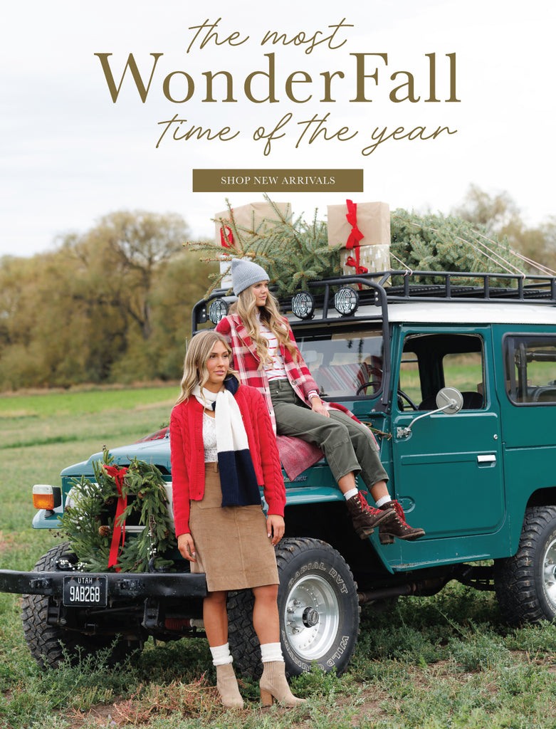 Two women standing next to a green SUV with Christmas decorations in a field. Promotional text overlay says "The Most WonderFall Time of the Year" and has a button that says "Shop New Arrivals"