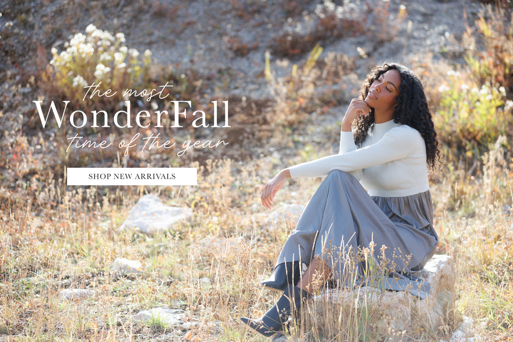 Woman sitting in a natural setting with promotional text overlay says "The Most WonderFall Time of the Year" and has a button that says "Shop New Arrivals"