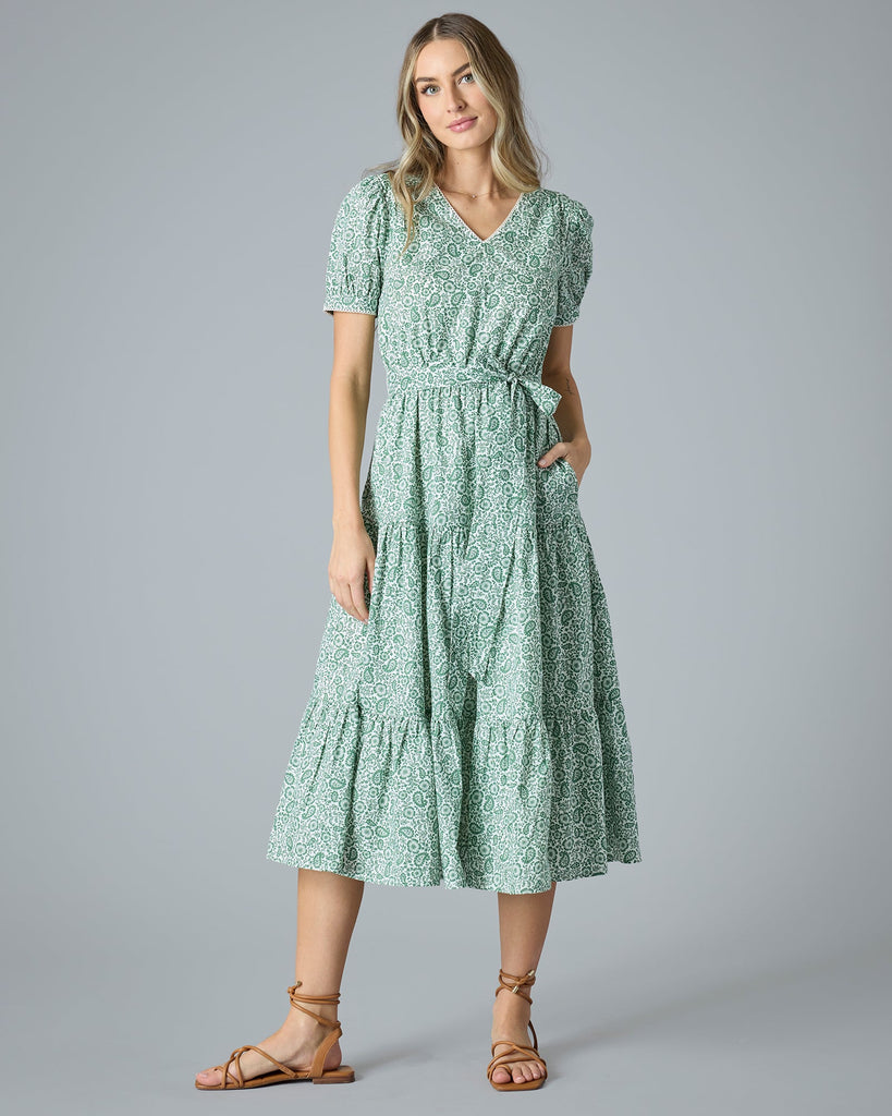 Woman in a green floral midi-length short sleeve dress