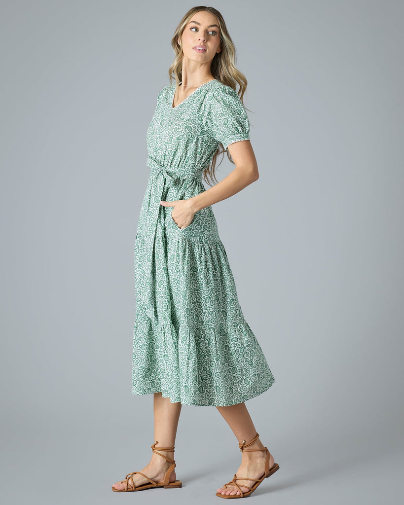 Woman in a green floral midi-length short sleeve dress