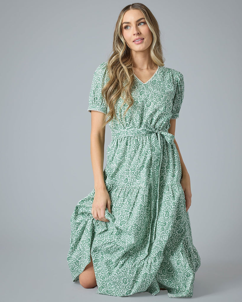 Woman in a green floral midi-length short sleeve dress