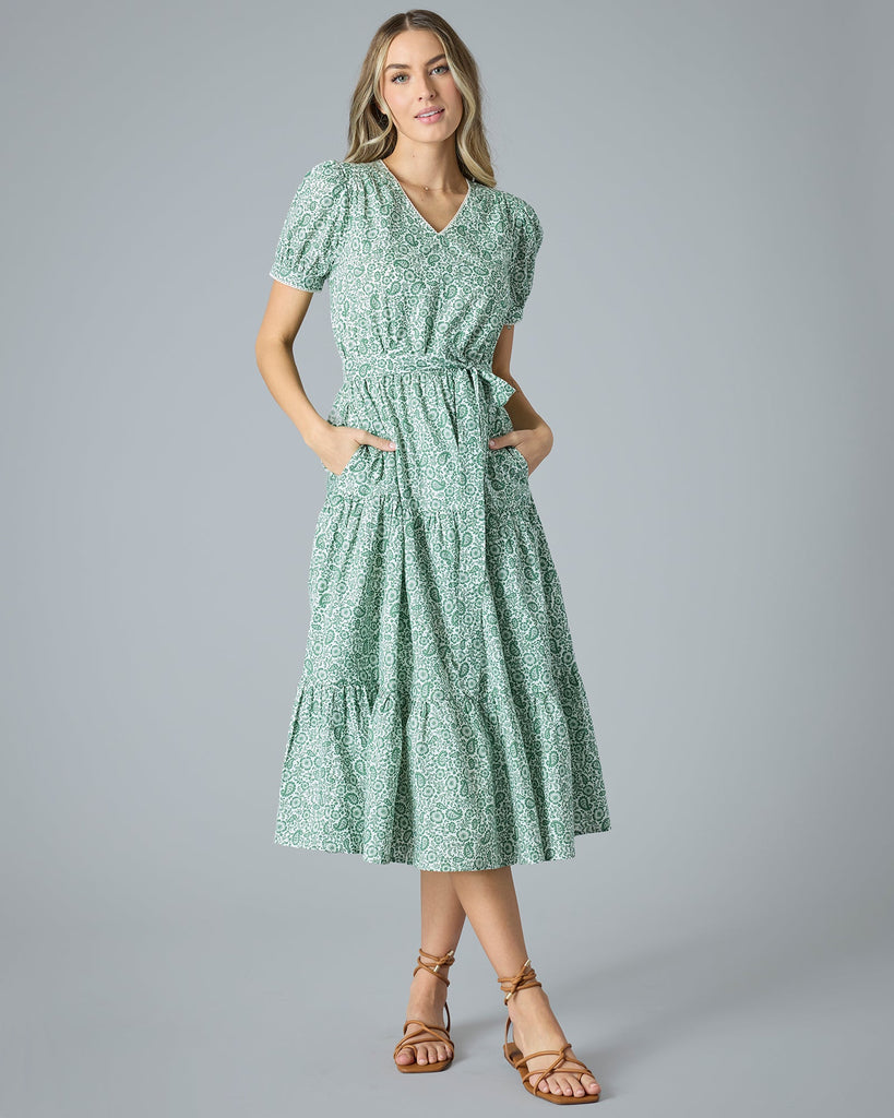 Woman in a green floral midi-length short sleeve dress