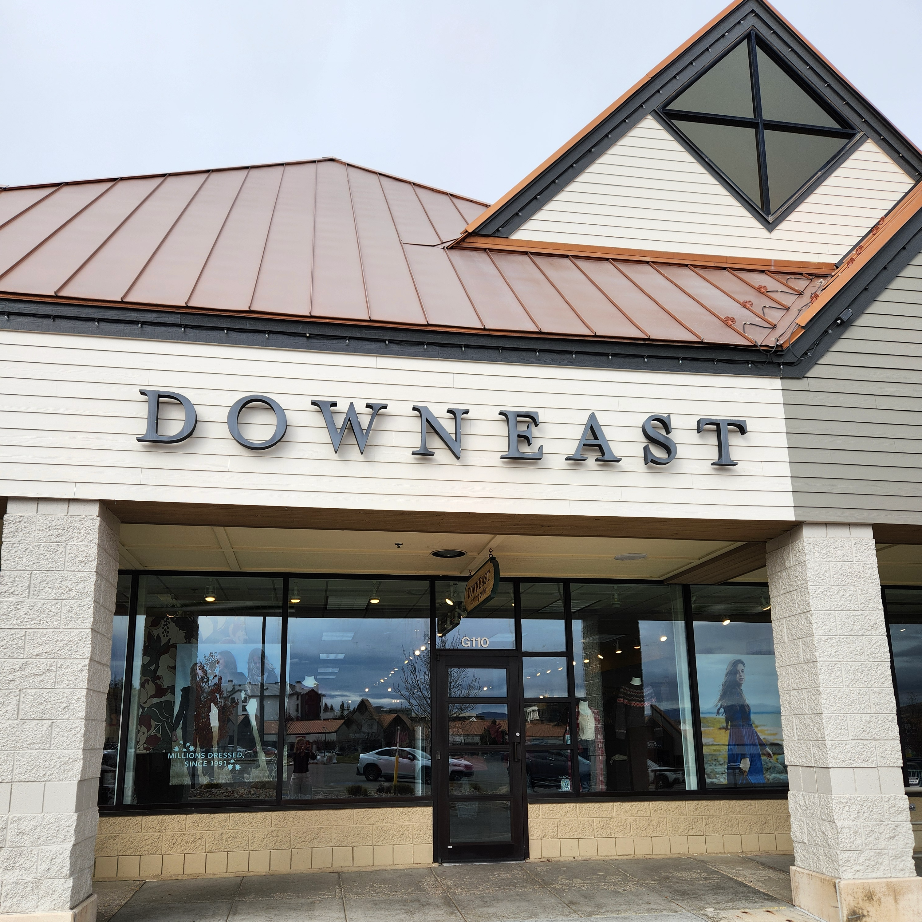 Storefront with 'Downeast' sign above glass door and windows