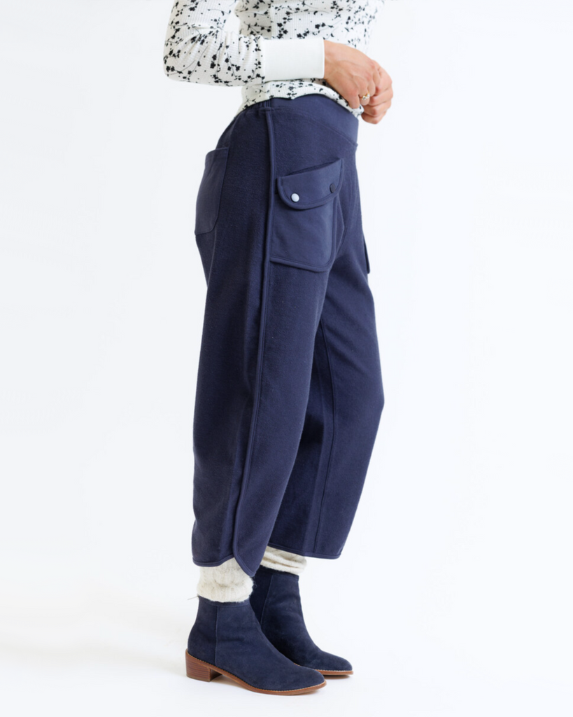 Person wearing navy blue pants on a white background