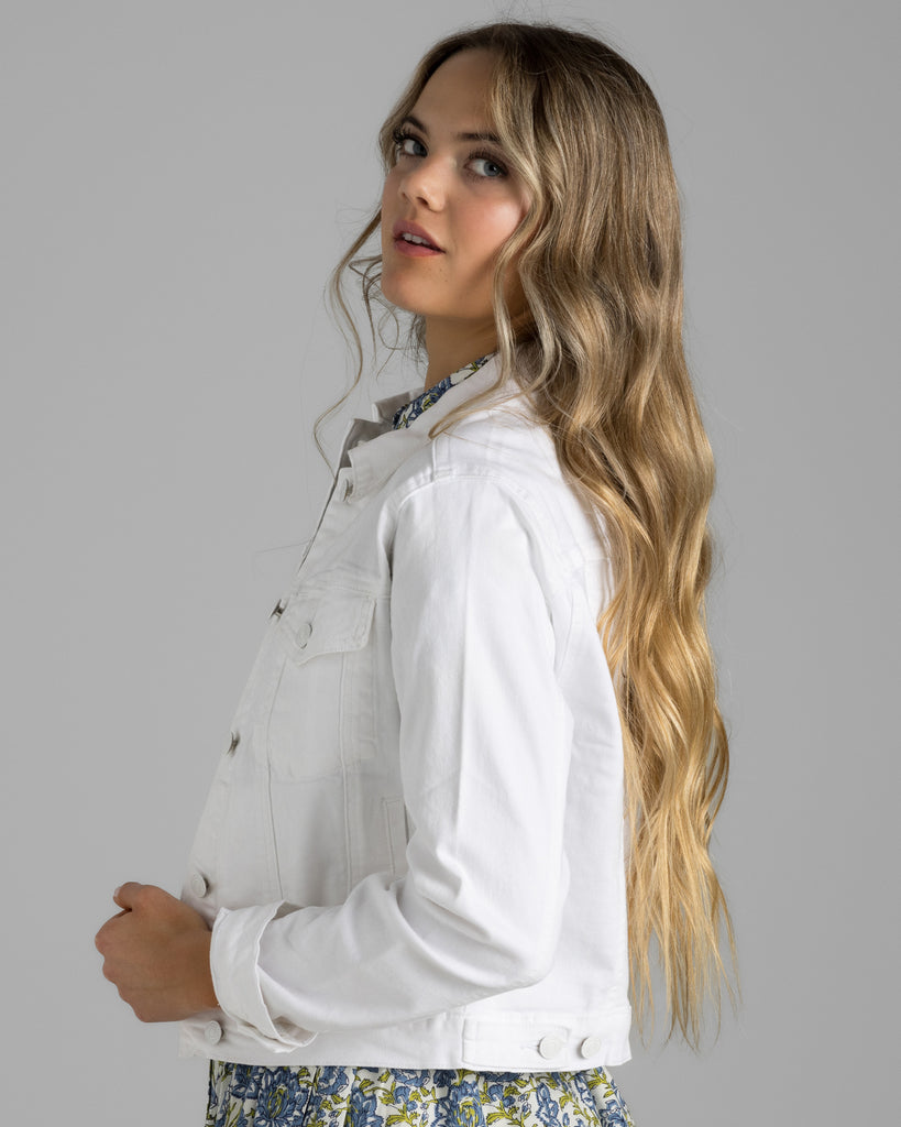 Model wearing a white denim long sleeve jacket.