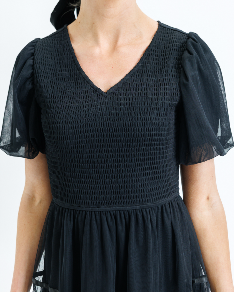 Black dress with tulle puff sleeves on a white background