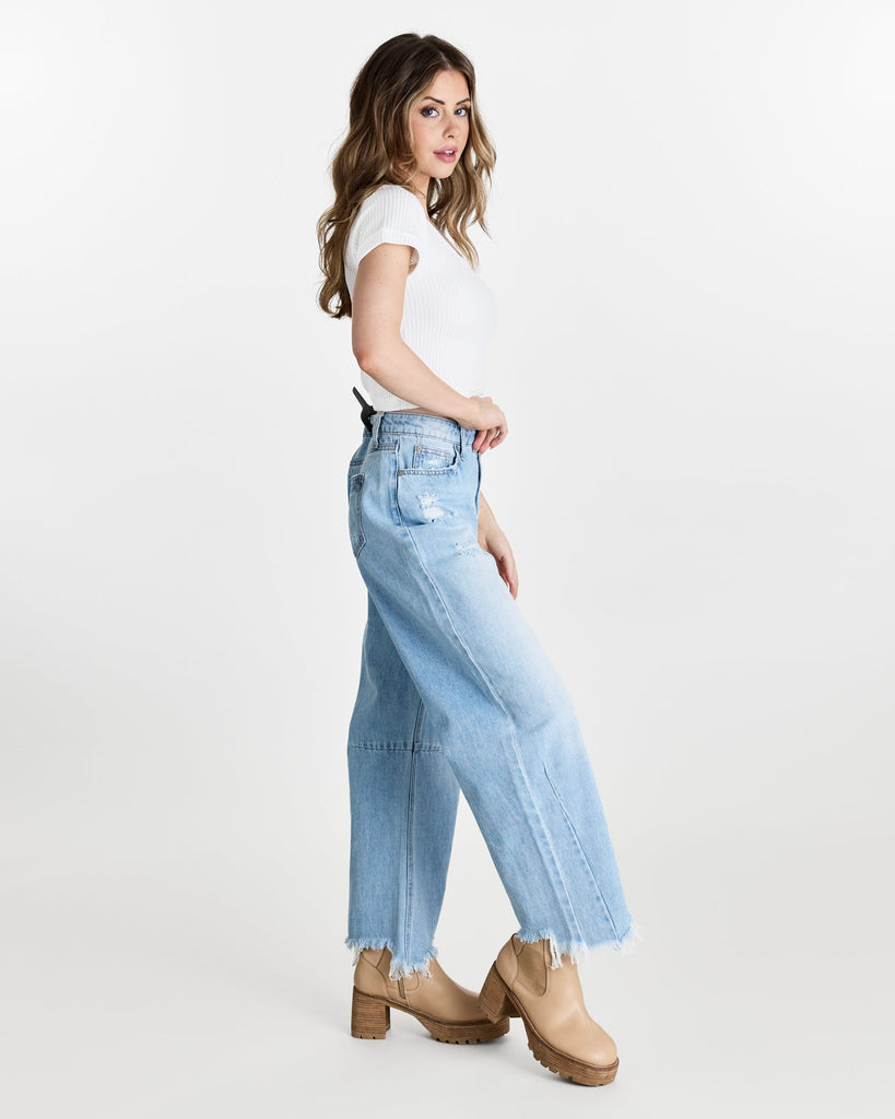 Woman in a white, short sleeved, crop top