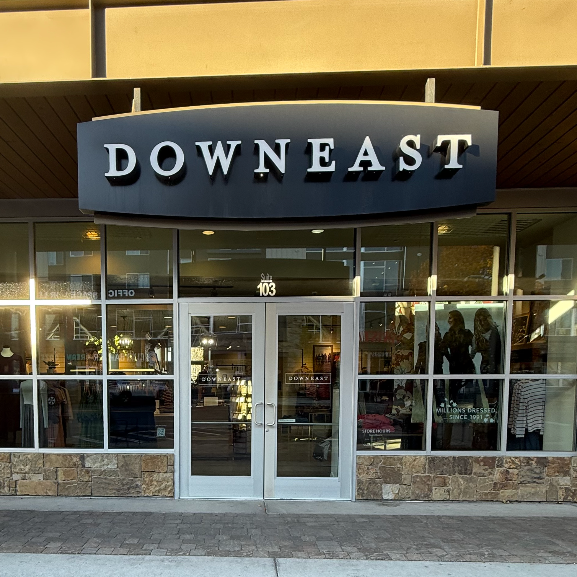 Storefront with 'Downeast' sign above glass door