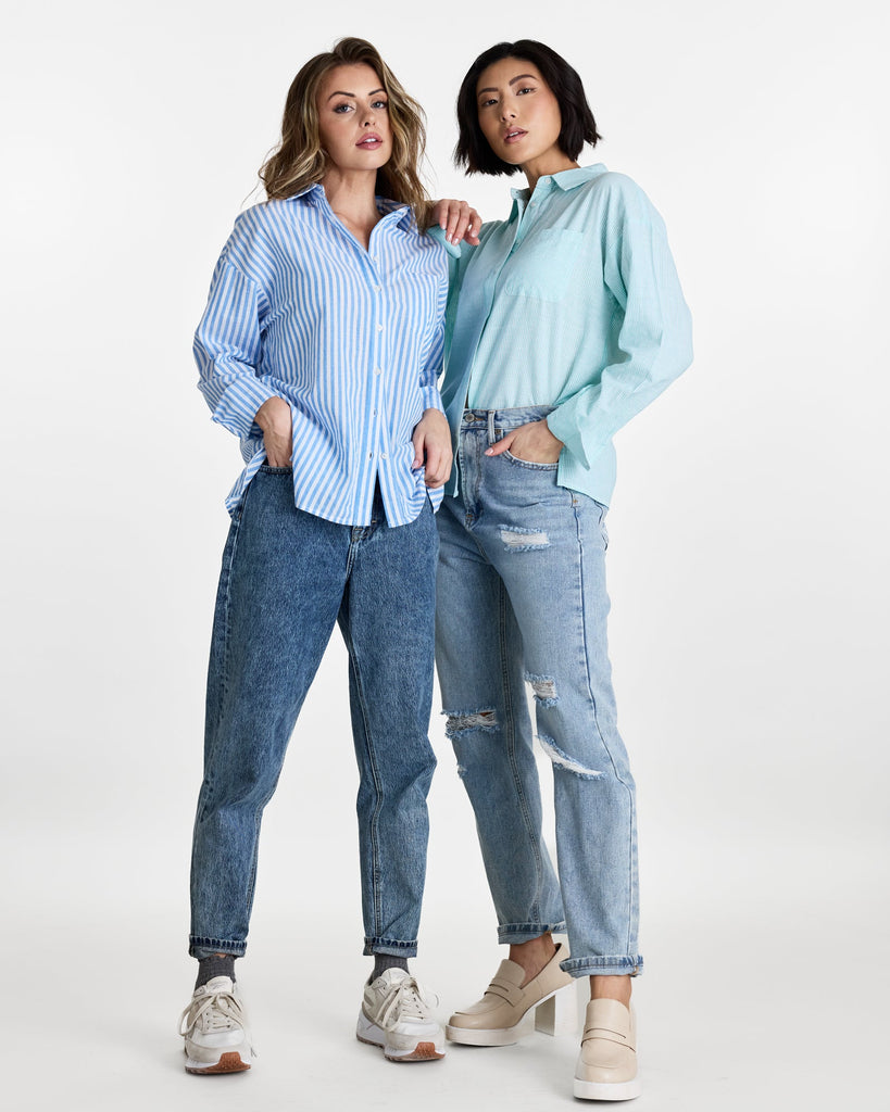 Woman in a long sleeve, striped, buttondown top