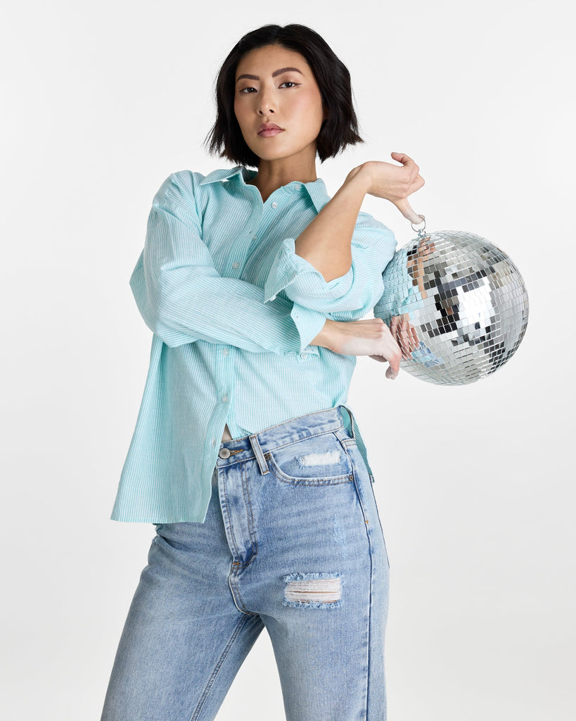 Woman in a long sleeve, striped, buttondown top