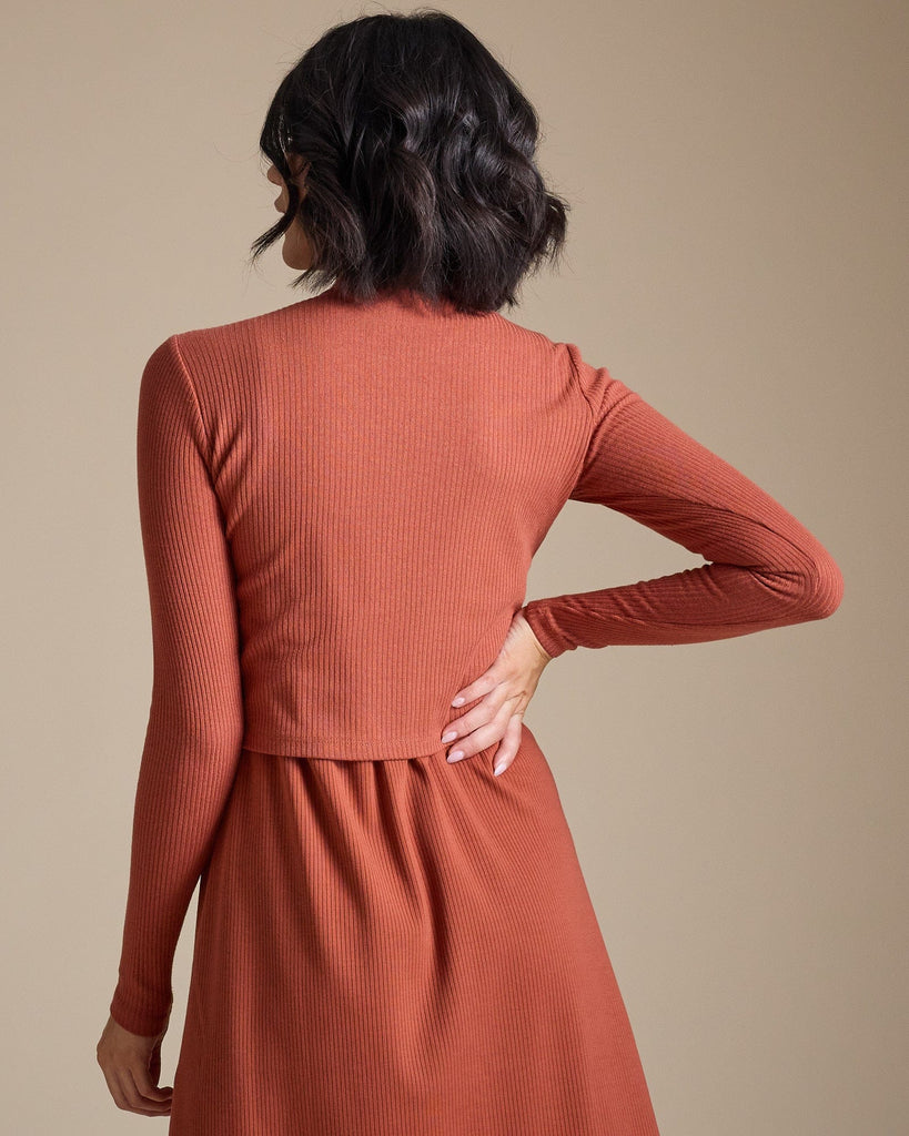 Woman in a burnt orange long sleeve ribbed cropped tee