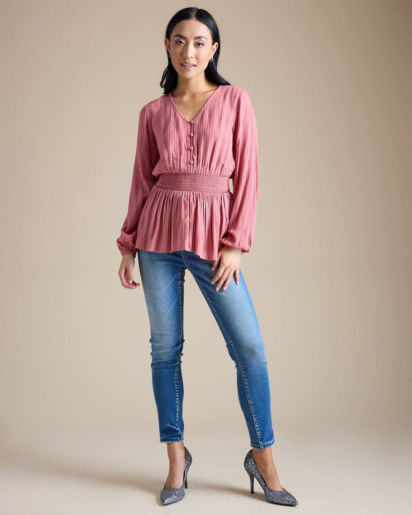 Woman in a pink long sleeve peplum blouse