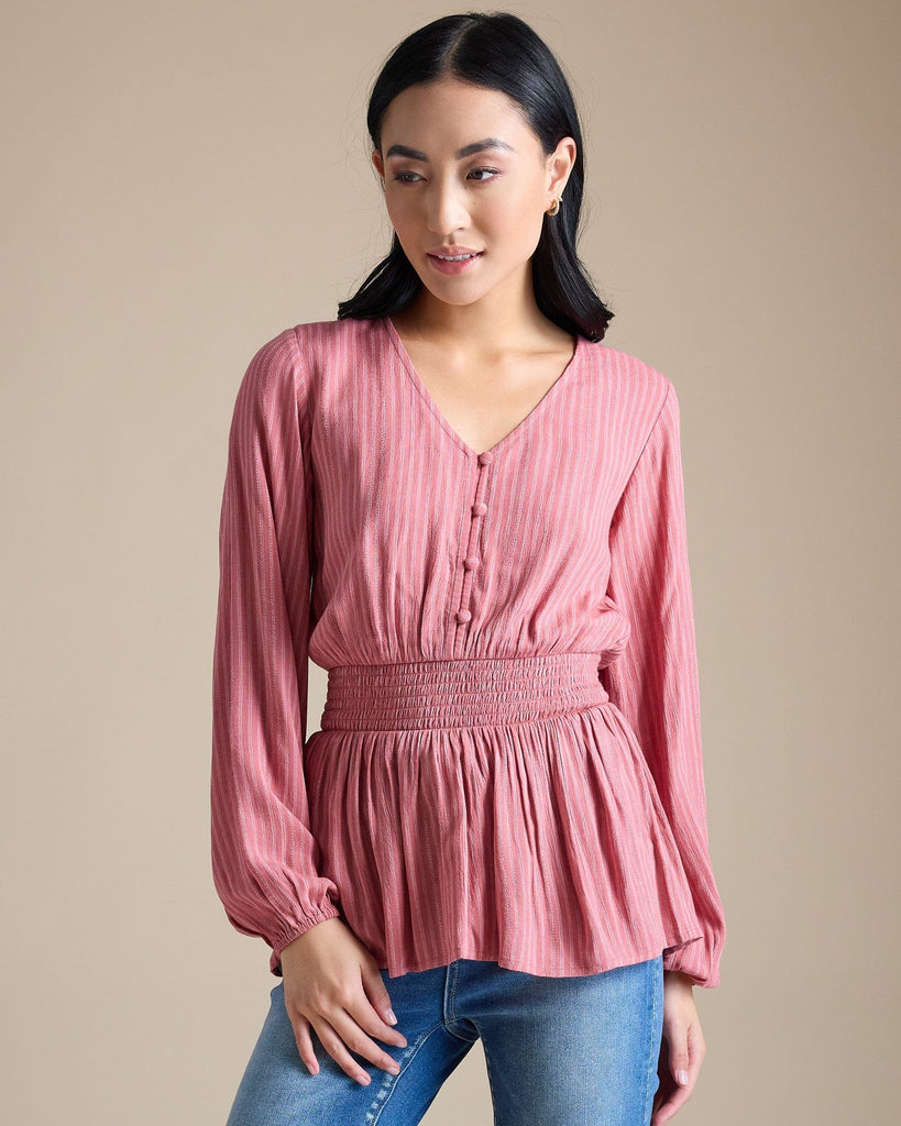 Woman in a pink long sleeve peplum blouse