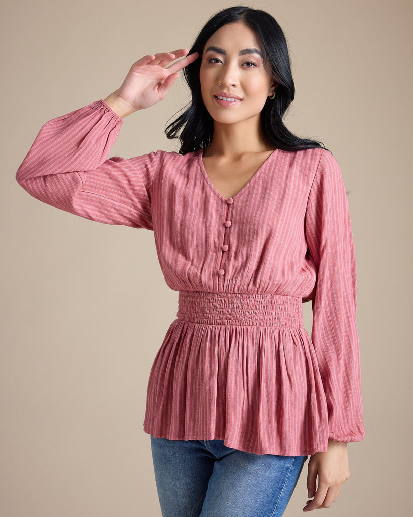 Woman in a pink long sleeve peplum blouse