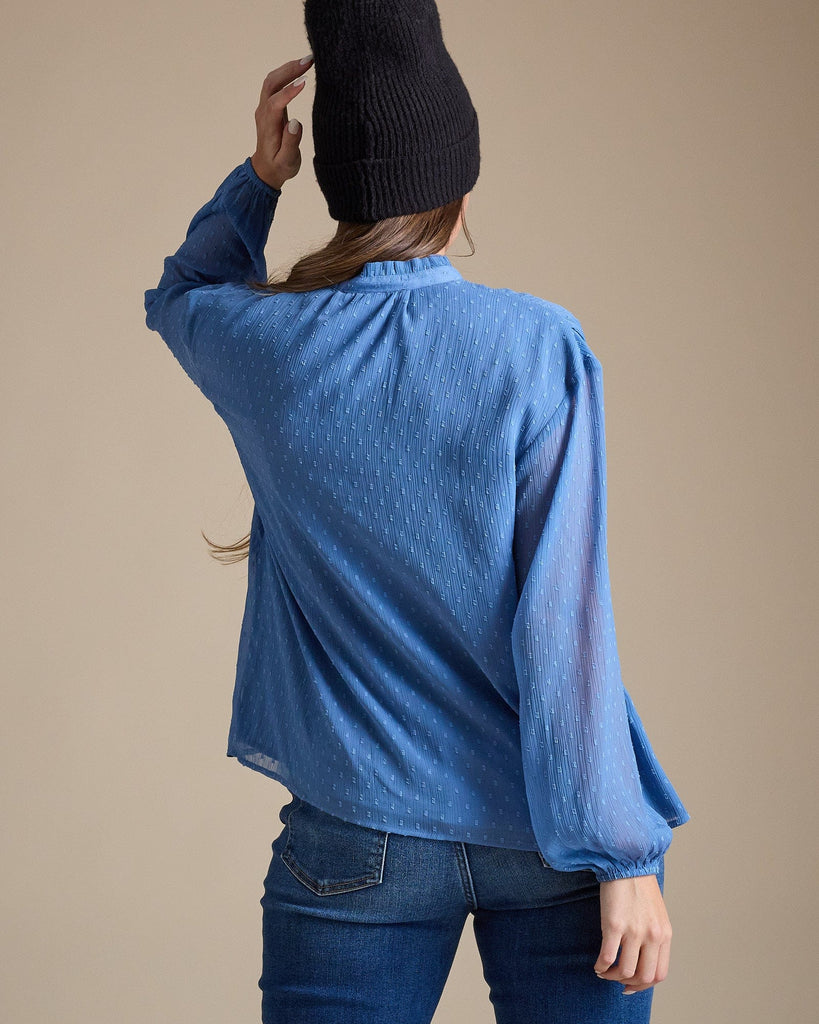 Woman in a dotted swiss blouse with long sleeves and a key-hole cutout