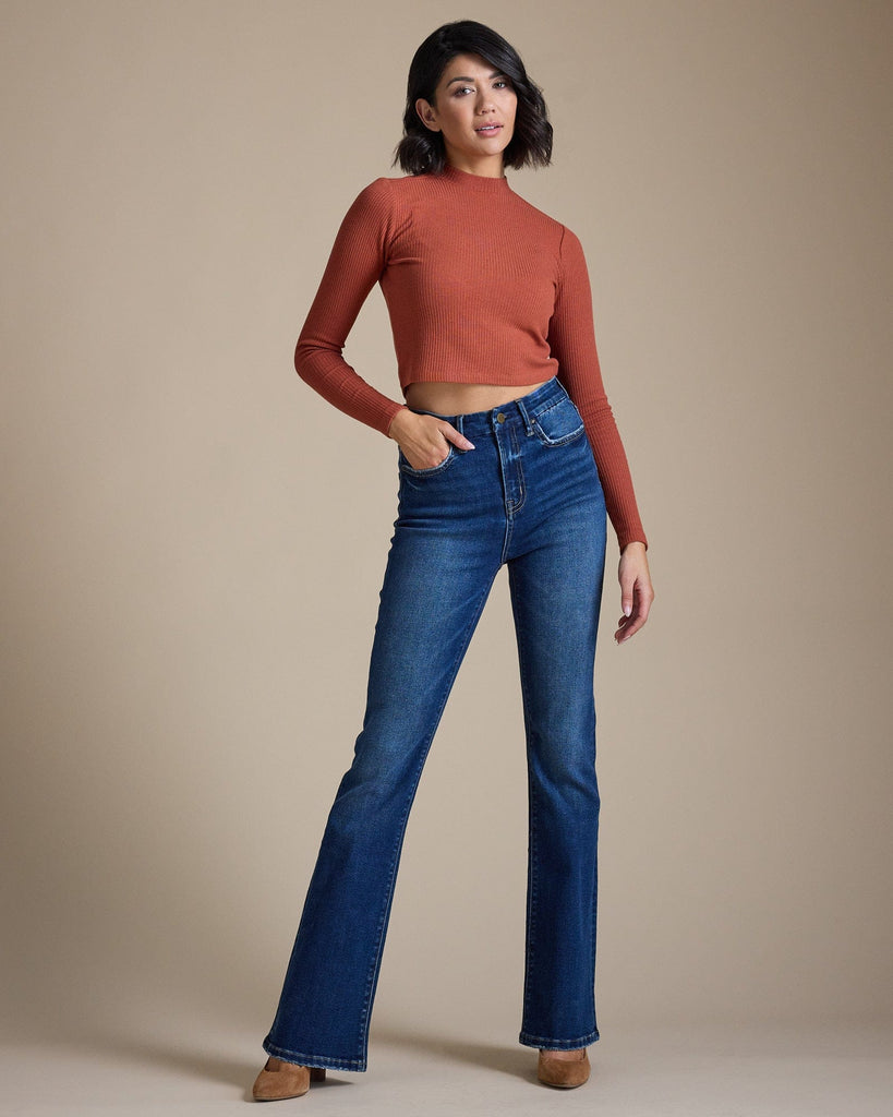 Woman in blue high-rise bootcut jeans