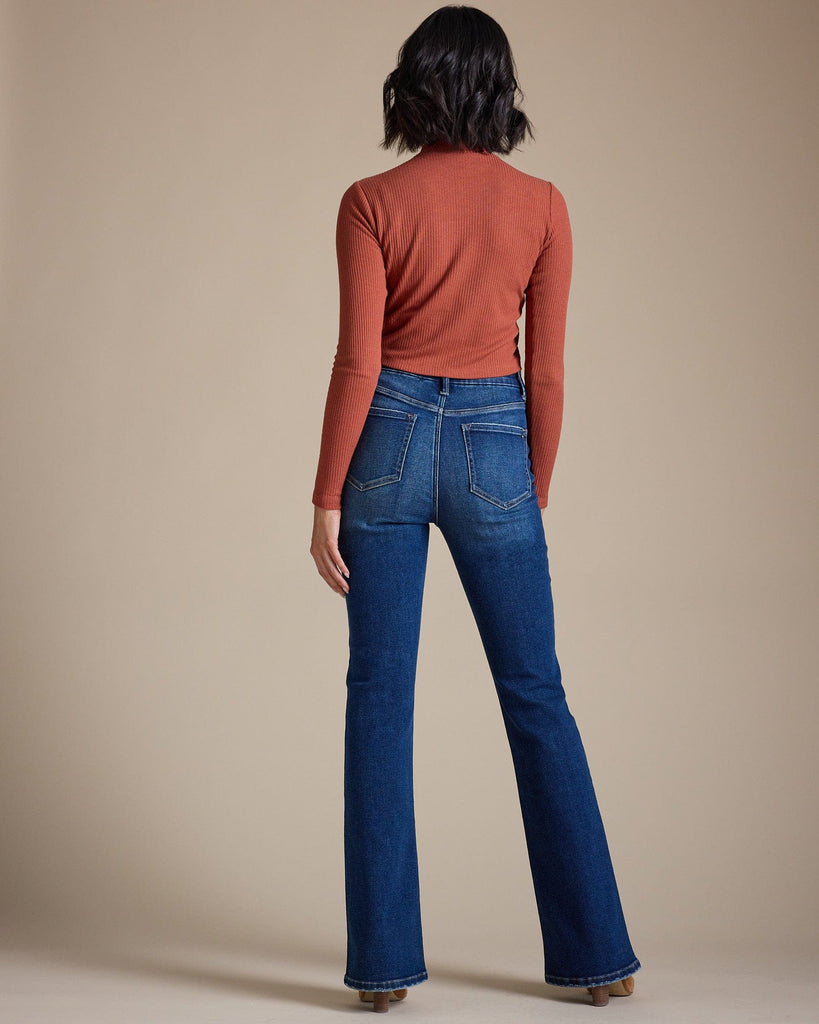 Woman in blue high-rise bootcut jeans