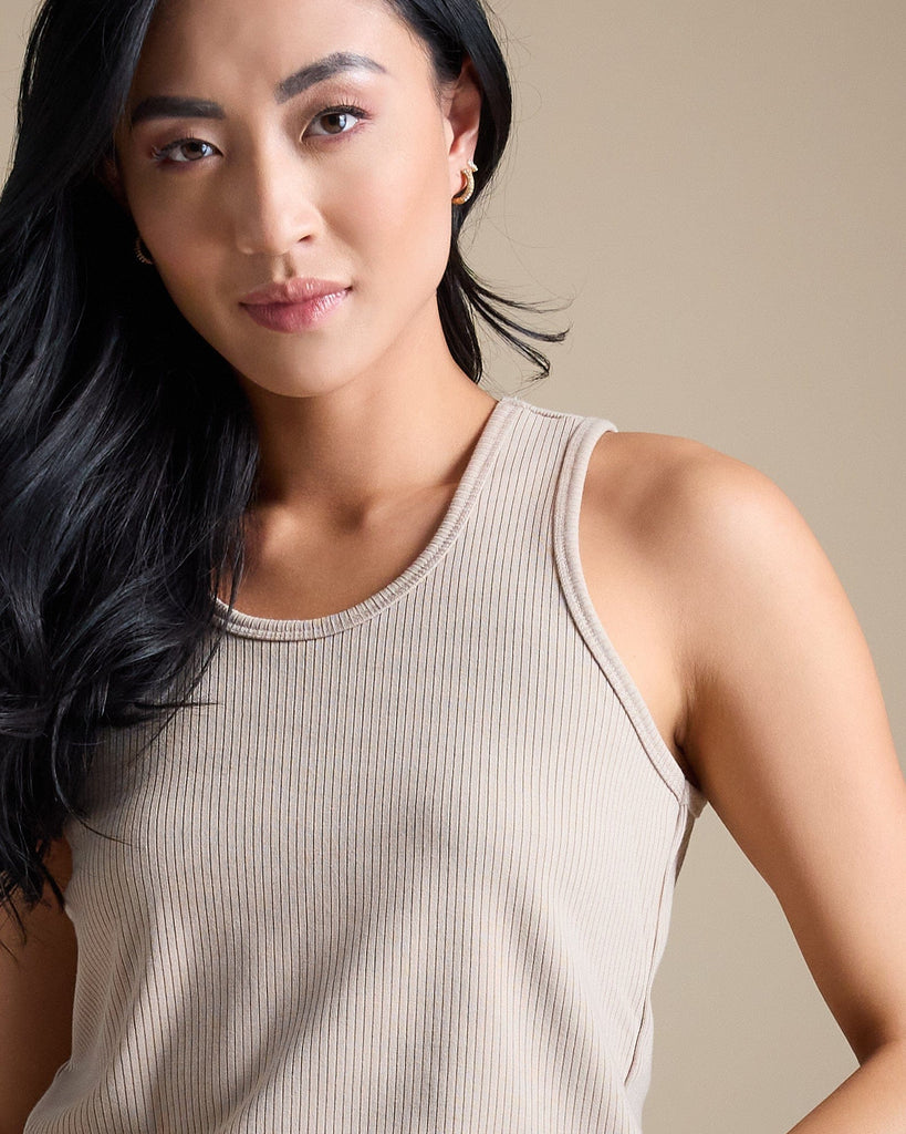 Woman in a tan sleeveless ribbed tank