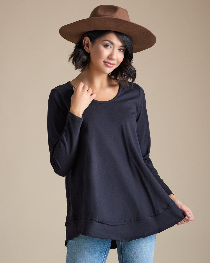 Woman in a black long sleeve flowy top