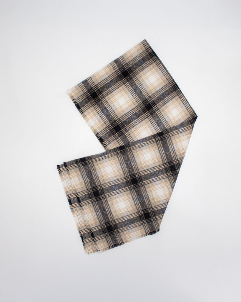 Plaid scarf with beige and black pattern on a white background