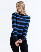 Woman wearing a black and blue striped sweater on a white background