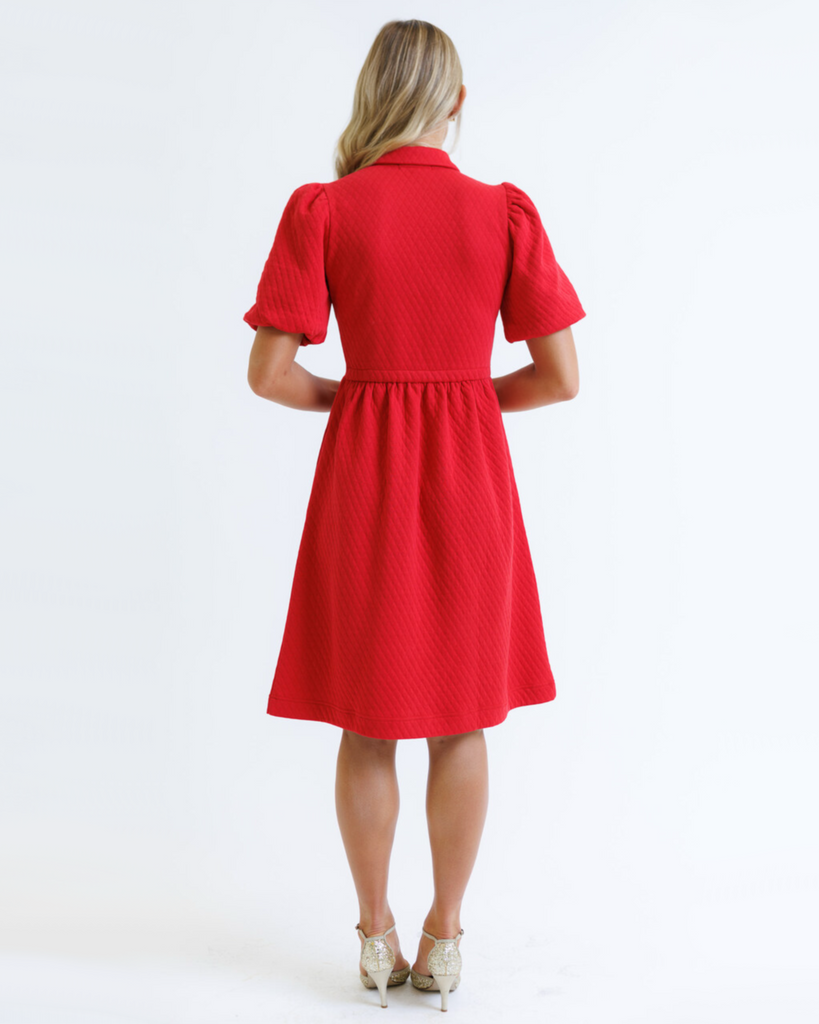 Woman wearing a red dress on a white background
