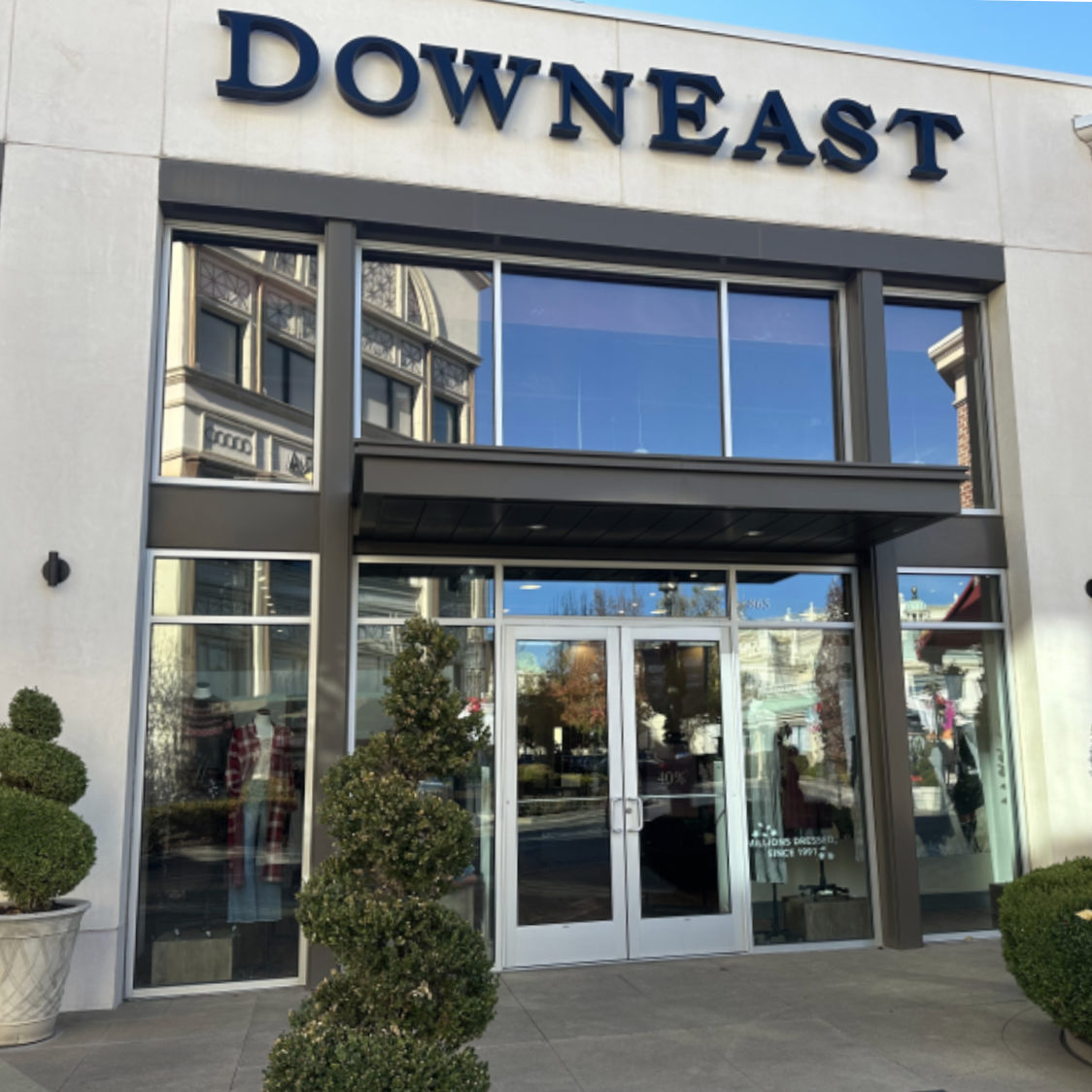 Storefront with 'Downeast' sign above glass doors