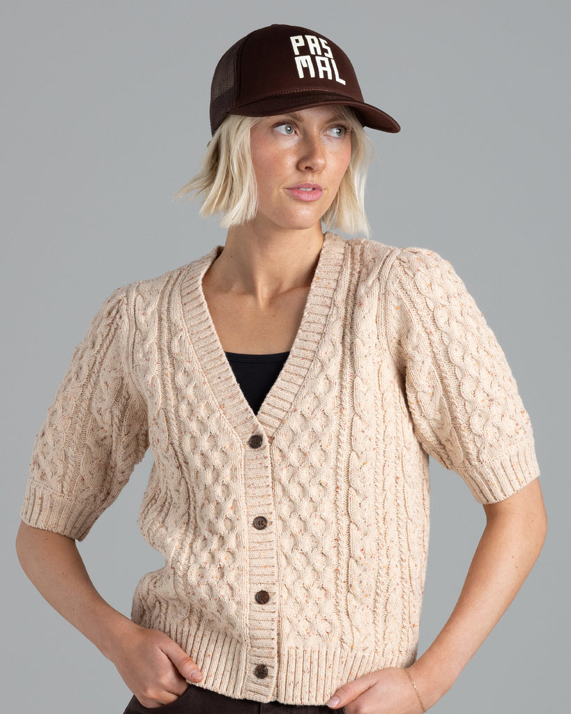 Model wearing a beige short sleeve v-neck cardigan.