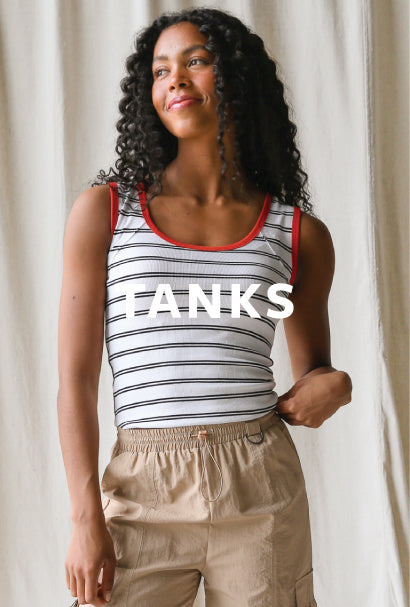 Image of a woman wearing a white and black striped tank with TANKS text