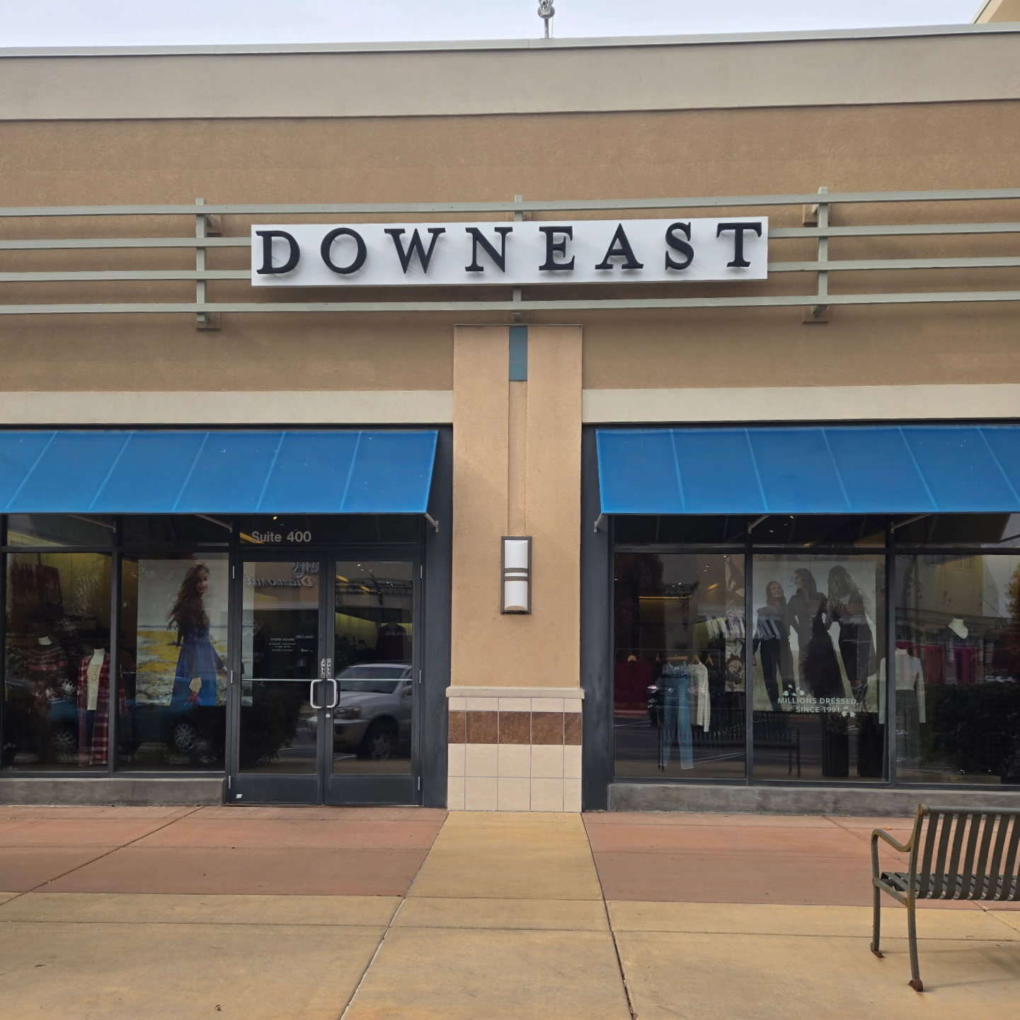 Storefront with 'Downeast' sign above glass doors and windows.