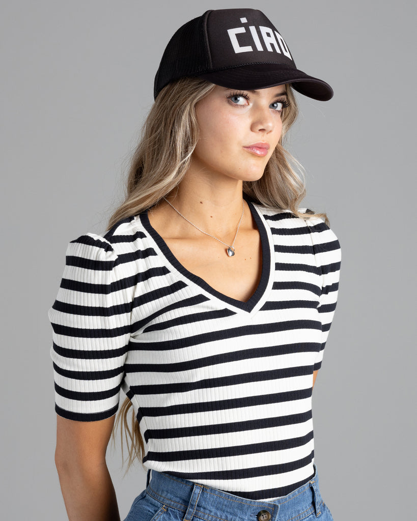 Model wearing a black and white striped, short sleeve, v-neck ribbed tshirt.