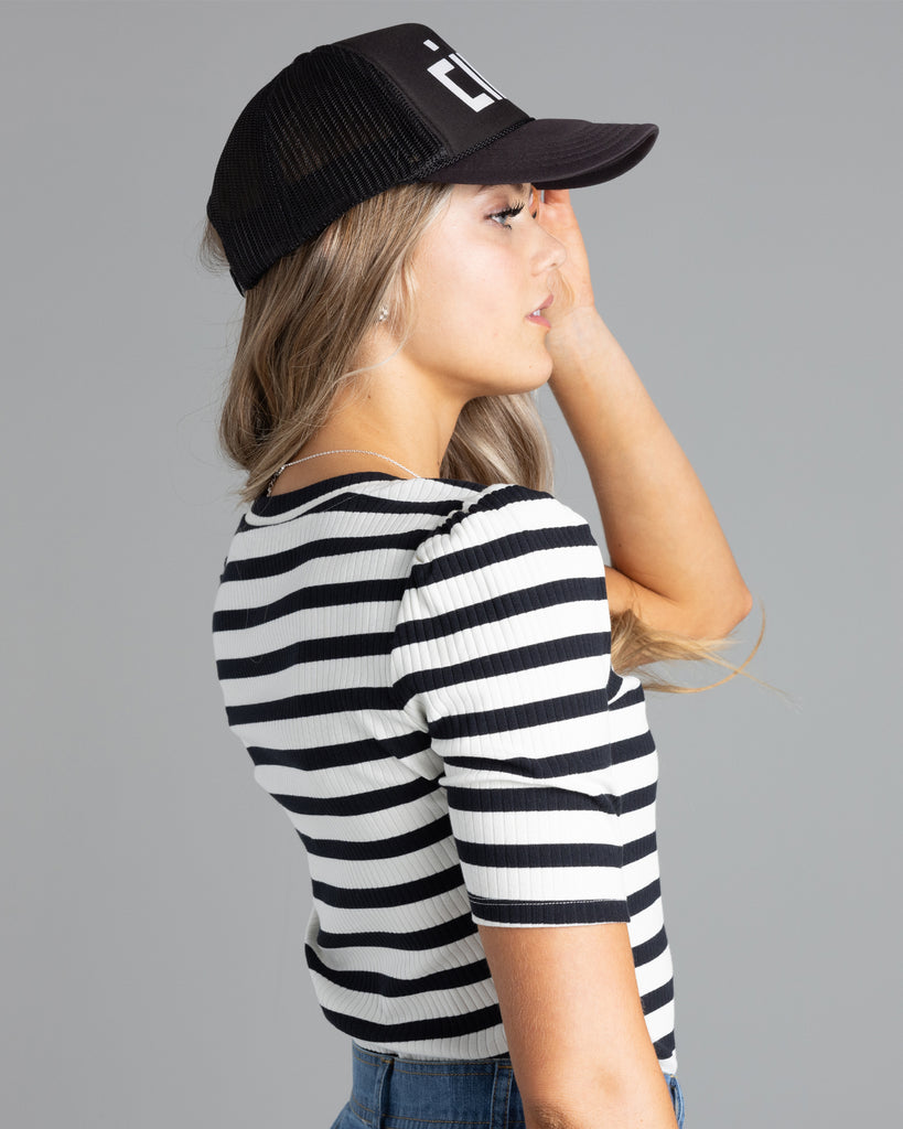 Model wearing a black and white striped, short sleeve, v-neck ribbed tshirt.