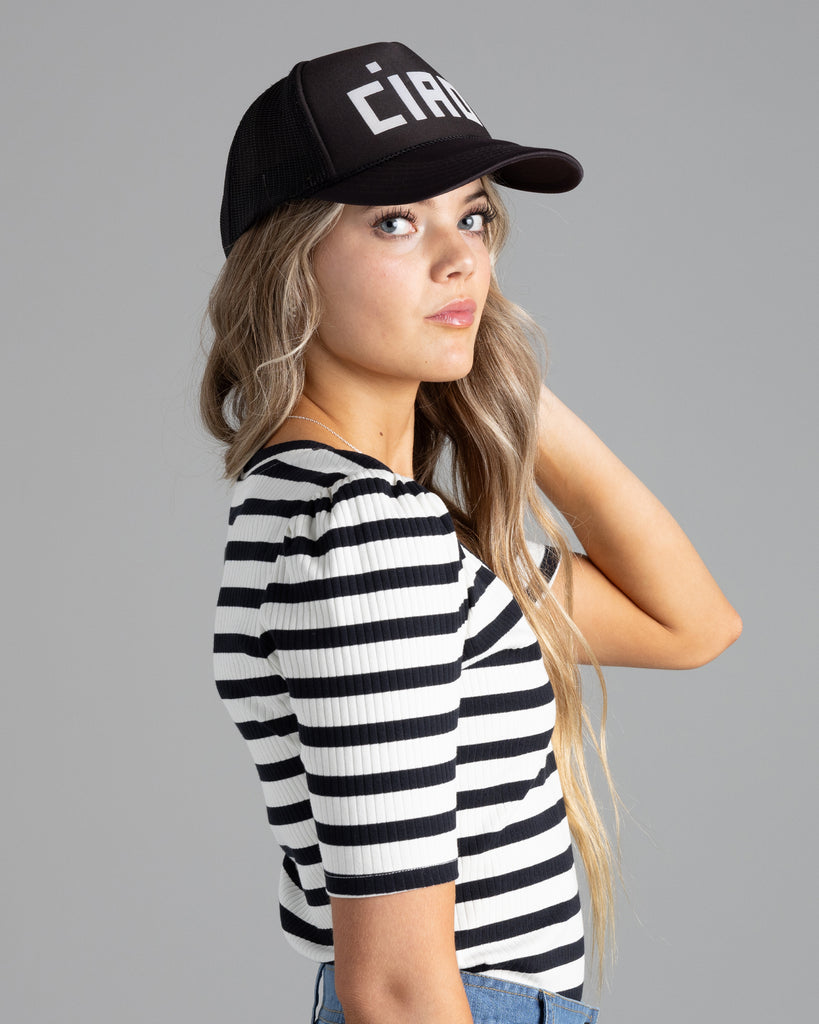 Model wearing a black and white striped, short sleeve, v-neck ribbed tshirt.