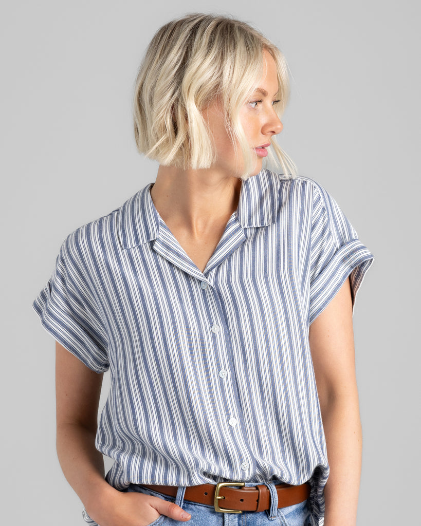 Model wearing a blue vertical striped short sleeve collared buttondown.