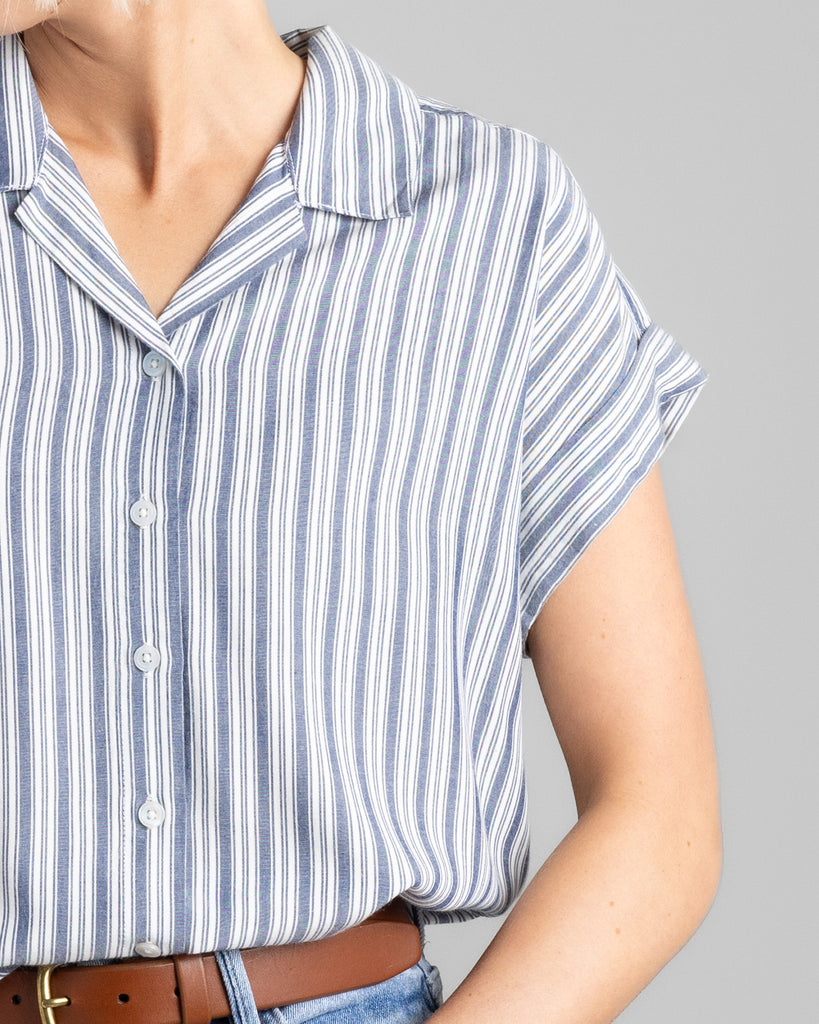 Model wearing a blue vertical striped short sleeve collared buttondown.