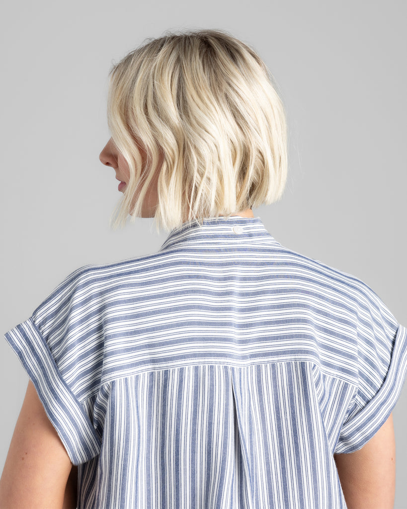 Model wearing a blue vertical striped short sleeve collared buttondown.