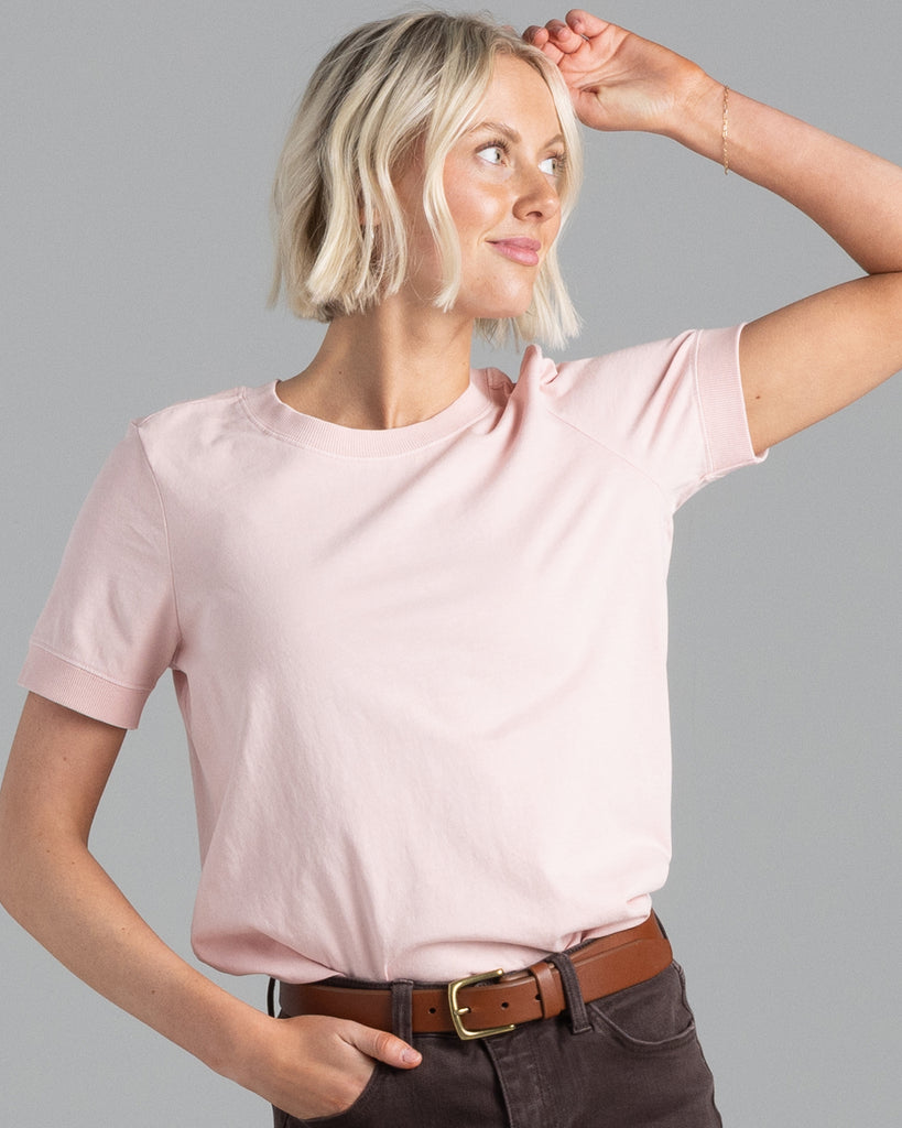 Model wearing a light pink, short sleeve basic tshirt.