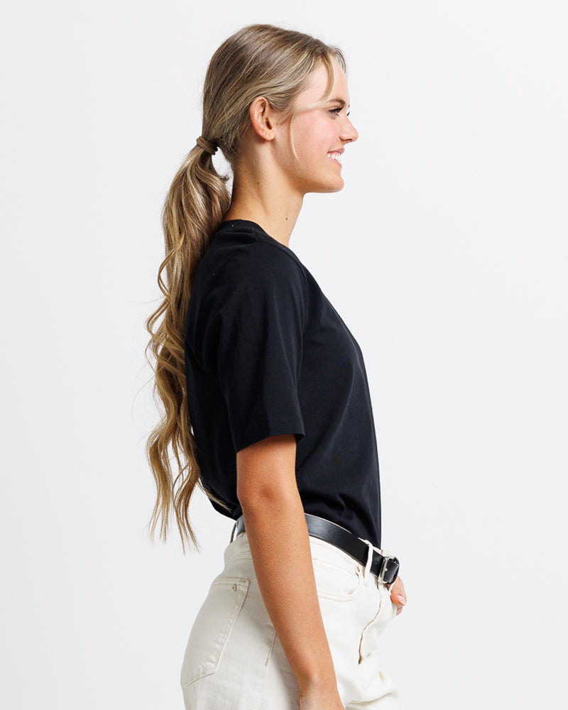 Model wearing a black short sleeve v-neck basic tee.